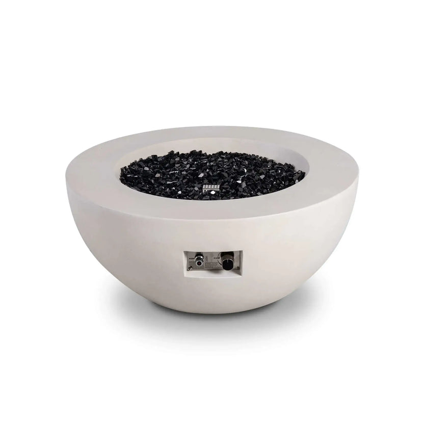 Front-facing studio image of the Flame Havens Refuge Series 36-inch Round Natural Gas White GFRC Concrete Fire Pit filled with premium black reflective tempered fire glass. The modern concrete bowl features a recessed stainless steel control panel and clean architectural lines, making it ideal for luxury residential and commercial outdoor living spaces.