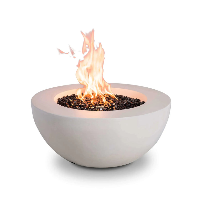 Studio product image of the Flame Havens Refuge Series 36-inch Round Natural Gas White GFRC Concrete Fire Pit with vibrant flames rising above premium black reflective tempered fire glass. The clean white concrete bowl, modern profile, and powerful natural gas flame create an elegant centerpiece for upscale outdoor entertaining areas.