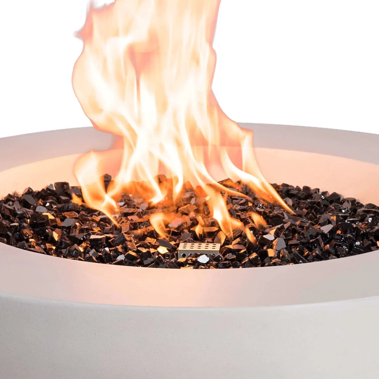 Close-up of the Flame Havens Refuge Series 36-inch Round Natural Gas White GFRC Concrete Fire Pit showcasing bright flames dancing above premium black reflective tempered fire glass. The image highlights the stainless steel CSA ignition system, reflective fire media, and realistic flame pattern that delivers warmth and visual appeal to luxury outdoor spaces.