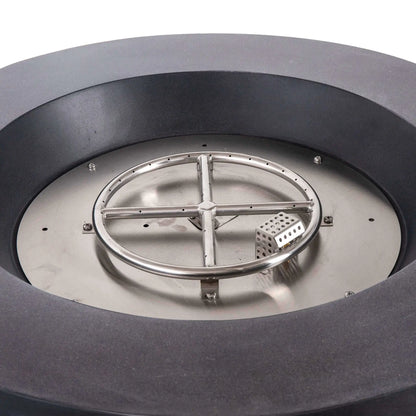 Close-up of the Flame Havens Refuge Series 36-inch Round Propane Gas GFRC Concrete Fire Pit with Black Reflective Fire Glass removed to reveal the stainless steel burner ring, burner pan, and CSA-certified ignition system. The image highlights the premium stainless steel construction engineered for reliable propane gas performance and long-lasting outdoor durability.