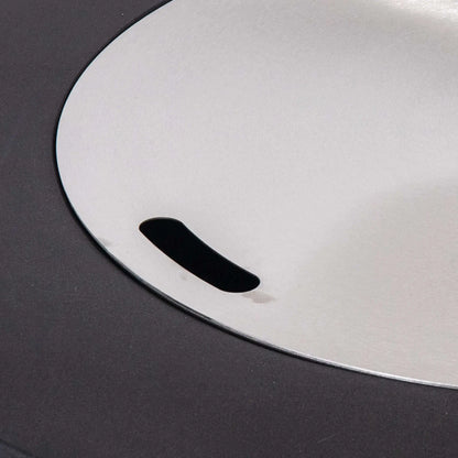 Close-up of the optional Stainless Steel Burner Cover installed on the Flame Havens Refuge Series 36-inch Round Propane Gas GFRC Concrete Fire Pit. The brushed stainless steel cover sits flush within the burner opening, transforming the fire pit into a functional tabletop while protecting the burner from weather and debris when not in use.
