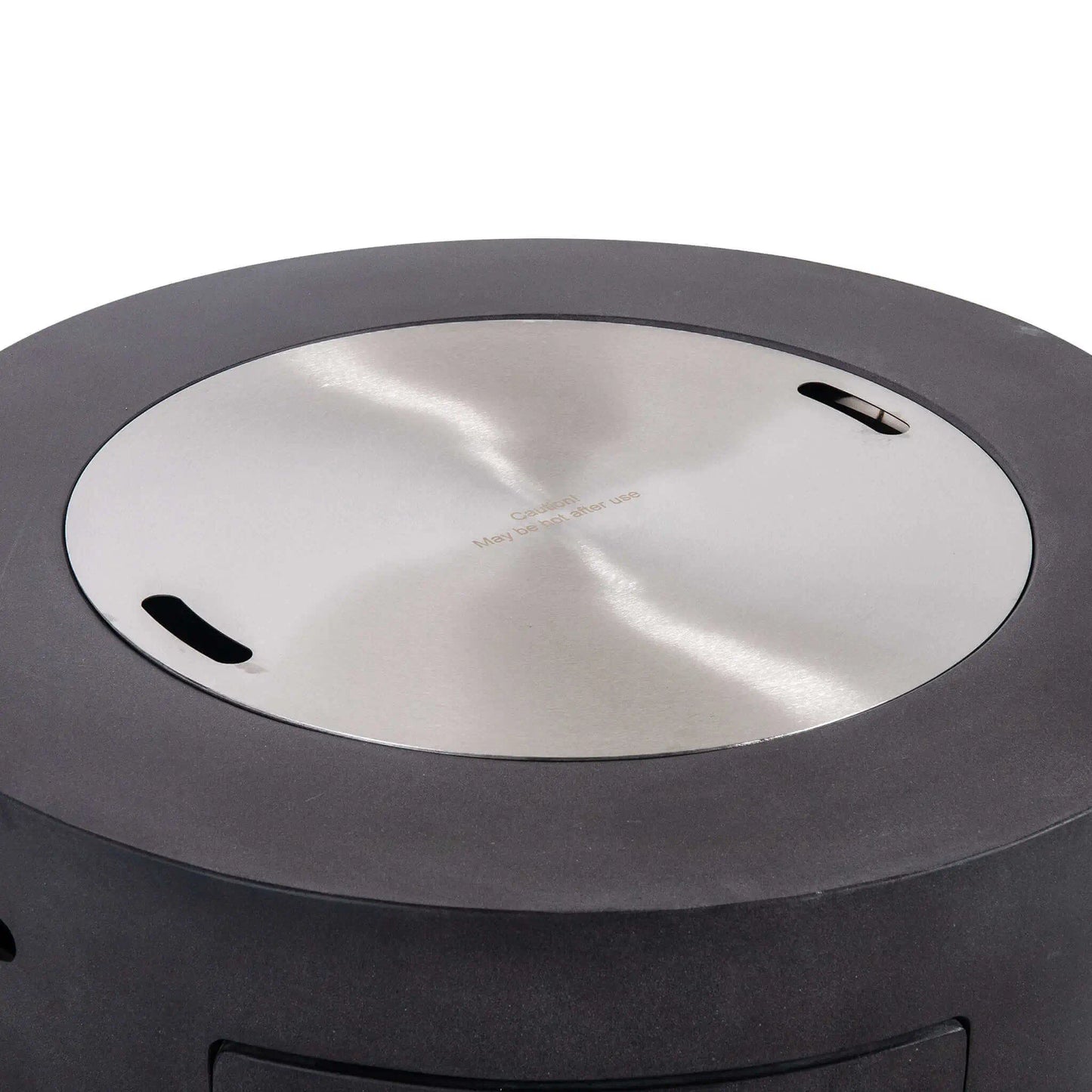 Flame Havens Refuge Series 36-inch Round Propane Gas GFRC Concrete Fire Pit in Graphite Black featuring the optional Stainless Steel Burner Cover installed flush within the burner opening. The brushed stainless steel cover transforms the fire pit into a functional tabletop while protecting the burner from weather, debris, and moisture when the fire feature is not in use.