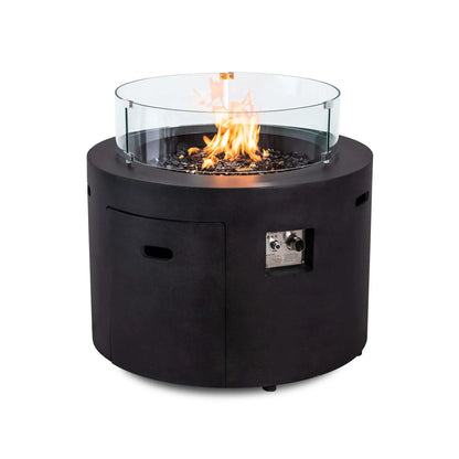 Flame Havens Refuge Series 36-inch Round Propane Gas GFRC Concrete Fire Pit featuring the optional tempered glass wind guard surrounding the natural propane flame. Premium Black Reflective Fire Glass, the Graphite Black GFRC concrete finish, and the clear glass wind guard combine to enhance flame protection while preserving an unobstructed view of the fire.