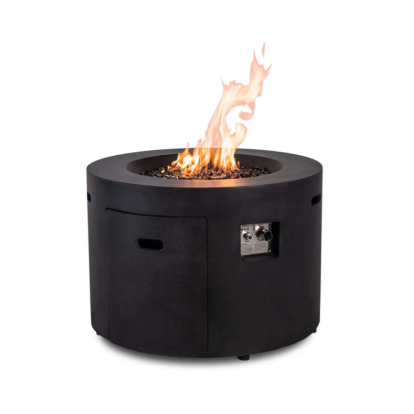 Front view of the Flame Havens Refuge Series 36-inch Round Propane Gas GFRC Concrete Fire Pit in Graphite Black operating with vibrant natural flames above premium Black Reflective Fire Glass. The image highlights the recessed CSA-certified ignition controls, hidden propane access door, and durable GFRC concrete construction, creating a modern centerpiece for luxury outdoor patios and backyard living spaces.