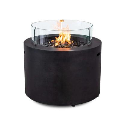 Flame Havens Refuge Series 36-inch Round Propane Gas GFRC Concrete Fire Pit featuring the optional tempered glass wind guard surrounding vibrant natural flames over premium Black Reflective Fire Glass. The Graphite Black GFRC concrete fire pit combines elegant modern styling with added flame protection, making it ideal for upscale patios, pool decks, and outdoor gathering spaces.