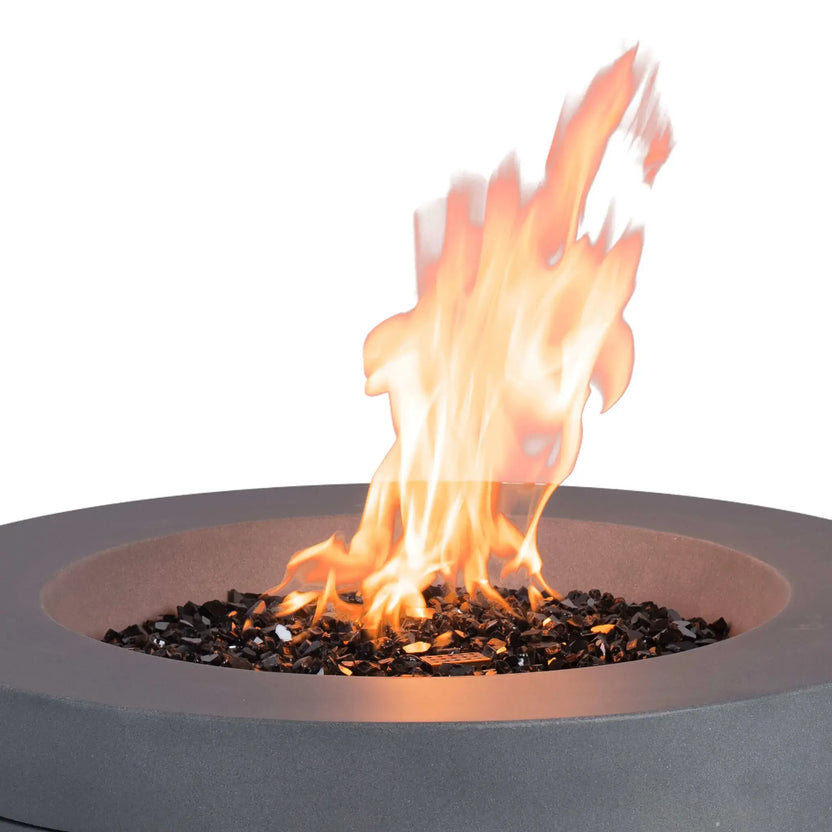 Close-up of the Flame Havens Refuge Series 36-inch Round Propane Gas GFRC Concrete Fire Pit in Natural Gray operating with tall natural propane flames rising above premium Black Reflective Fire Glass. The image highlights the stainless steel burner system, vibrant flame presentation, and durable GFRC concrete construction designed for elegant outdoor living spaces.