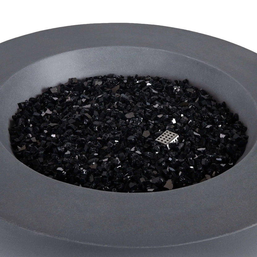 Close-up of the Flame Havens Refuge Series 36-inch Round Propane Gas GFRC Concrete Fire Pit in Natural Gray featuring premium Black Reflective Fire Glass with the burner off. The image showcases the smooth GFRC concrete finish, generous burner basin, and stainless steel ignitor housing concealed beneath the decorative fire glass for a refined contemporary appearance.