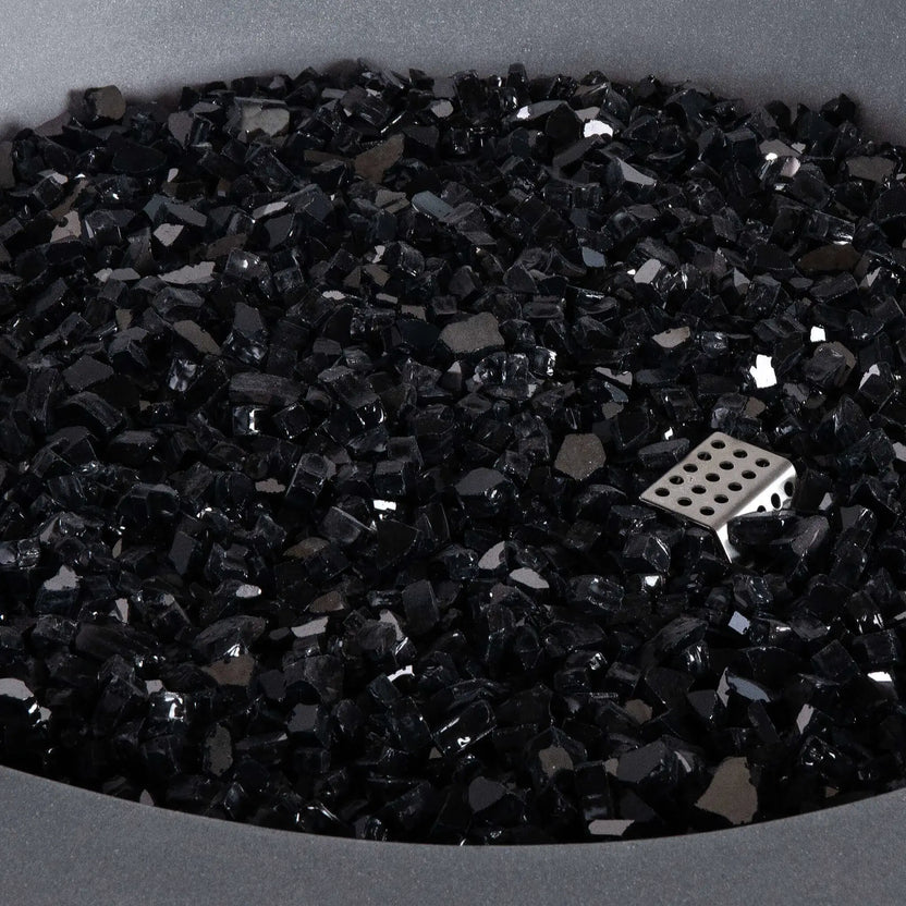 Detailed close-up of the Flame Havens Refuge Series 36-inch Round Propane Gas GFRC Concrete Fire Pit featuring premium Black Reflective Fire Glass. The image highlights the reflective tempered glass media, concealed stainless steel ignitor, and smooth Natural Gray GFRC concrete finish, emphasizing the premium materials used throughout the Refuge Series fire pit.