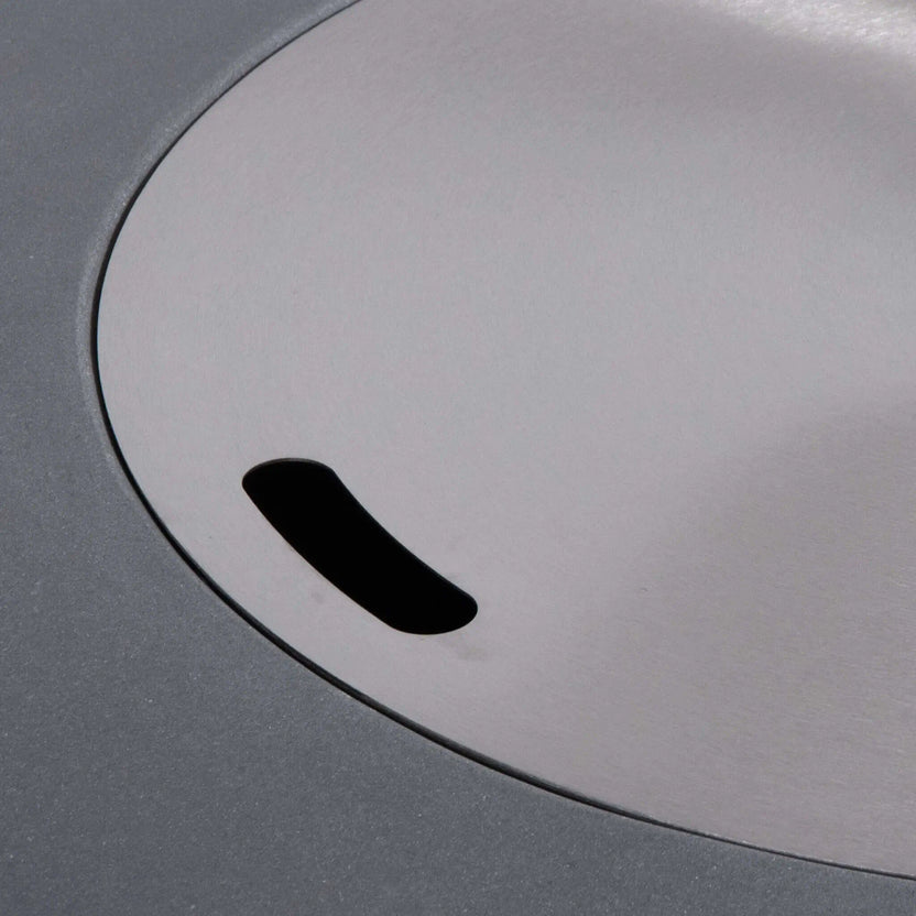 Close-up of the optional stainless steel burner cover installed on the Flame Havens Refuge Series 36-inch Round Propane Gas GFRC Concrete Fire Pit in Natural Gray. The precision-fit cover creates a smooth tabletop surface while protecting the burner and fire glass when the fire pit is not in use, adding both functionality and modern style.