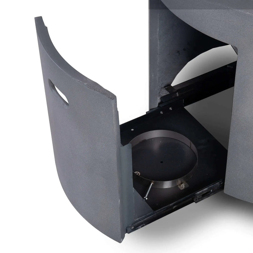 The hidden propane drawer of the Flame Havens Refuge Series 36-inch Round Propane Gas GFRC Concrete Fire Pit in Natural Gray shown extended to reveal the integrated slide-out propane tank compartment. The image demonstrates the convenient concealed storage system that keeps the propane cylinder hidden while allowing quick access for replacement.