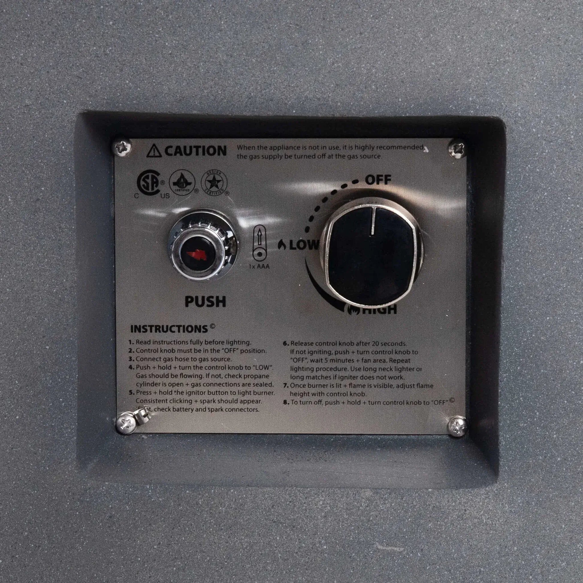 Close-up of the recessed control panel on the Flame Havens Refuge Series 36-inch Round Propane Gas GFRC Concrete Fire Pit. The image showcases the CSA-certified stainless steel ignition plate, push-button igniter, adjustable flame control knob, lighting instructions, and durable GFRC concrete surround for safe and reliable propane gas operation.
