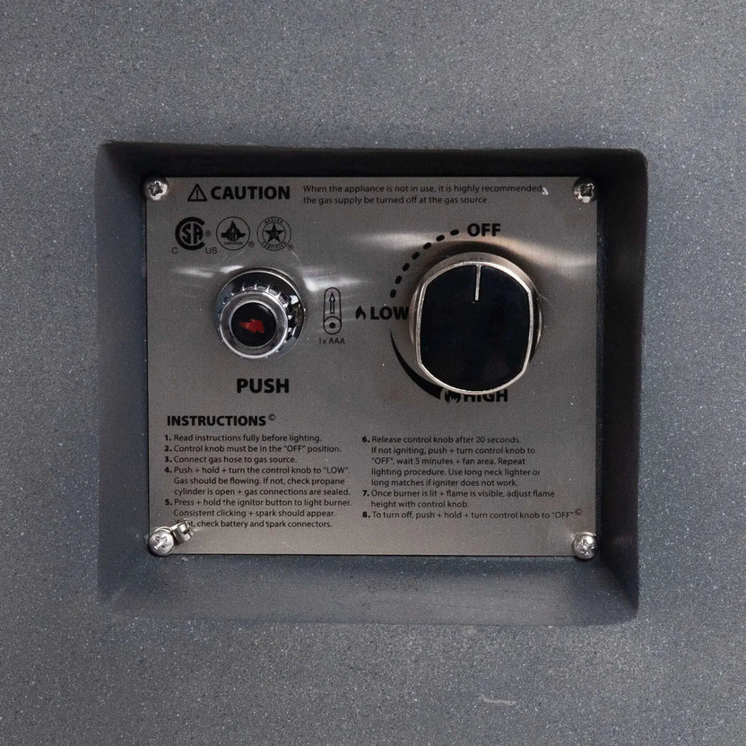 Close-up of the recessed control panel on the Flame Havens Refuge Series 36-inch Round Propane Gas GFRC Concrete Fire Pit. The image showcases the CSA-certified stainless steel ignition plate, push-button igniter, adjustable flame control knob, lighting instructions, and durable GFRC concrete surround for safe and reliable propane gas operation.