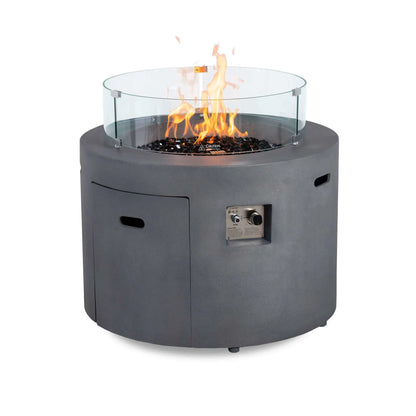 Rear view of the Flame Havens Refuge Series 36-inch Round Propane Gas GFRC Concrete Fire Pit in Natural Gray featuring tall flames, premium Black Reflective Fire Glass, and the optional tempered glass wind guard. The image demonstrates how the wind guard surrounds the burner while maintaining an unobstructed view of the flame and protecting it from outdoor breezes.
