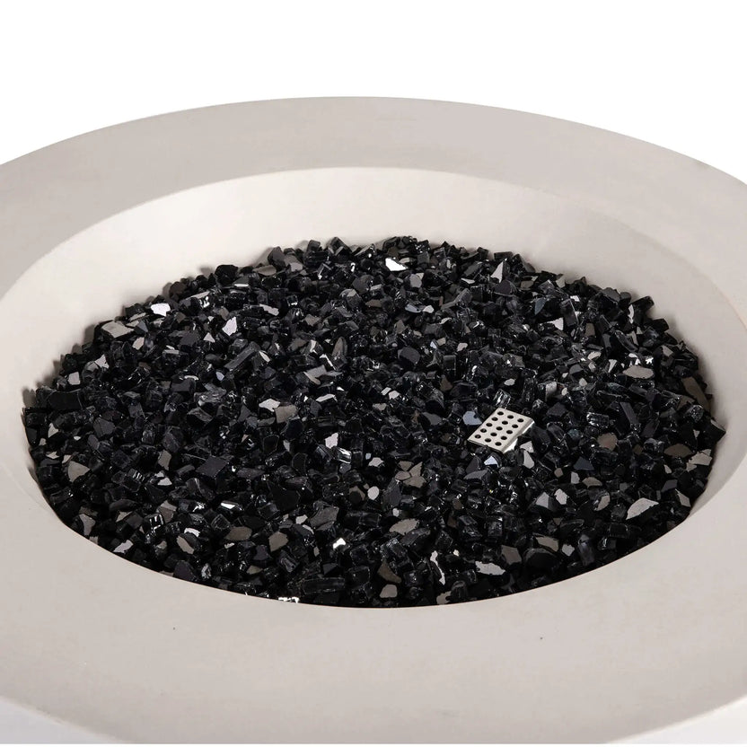 Top-down view of the Flame Havens Refuge Series 36-inch Round Propane Gas GFRC Concrete Fire Pit in Ivory White, showcasing premium Black Reflective Fire Glass evenly covering the stainless steel burner assembly. The image highlights the clean circular burner opening, modern GFRC concrete construction, and luxurious fire media designed to enhance outdoor patio and backyard fire pit installations.