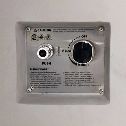 Close-up of the CSA-certified ignition control panel on the Flame Havens Refuge Series 36-inch Round Propane Gas GFRC Concrete Fire Pit in Ivory White. The recessed stainless steel panel features the push-button igniter, flame adjustment control knob, OFF-LOW-HIGH settings, lighting instructions, and safety certifications for reliable propane gas operation.