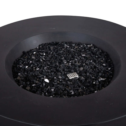 Top-down view of the Flame Havens Refuge Series 43-inch Round Natural Gas GFRC Concrete Fire Pit in Black, showcasing the premium black concrete finish filled with reflective black fire glass. A stainless steel CSA-certified ignition component is subtly visible among the fire glass, highlighting the clean burner design and modern aesthetic for luxury outdoor living spaces.