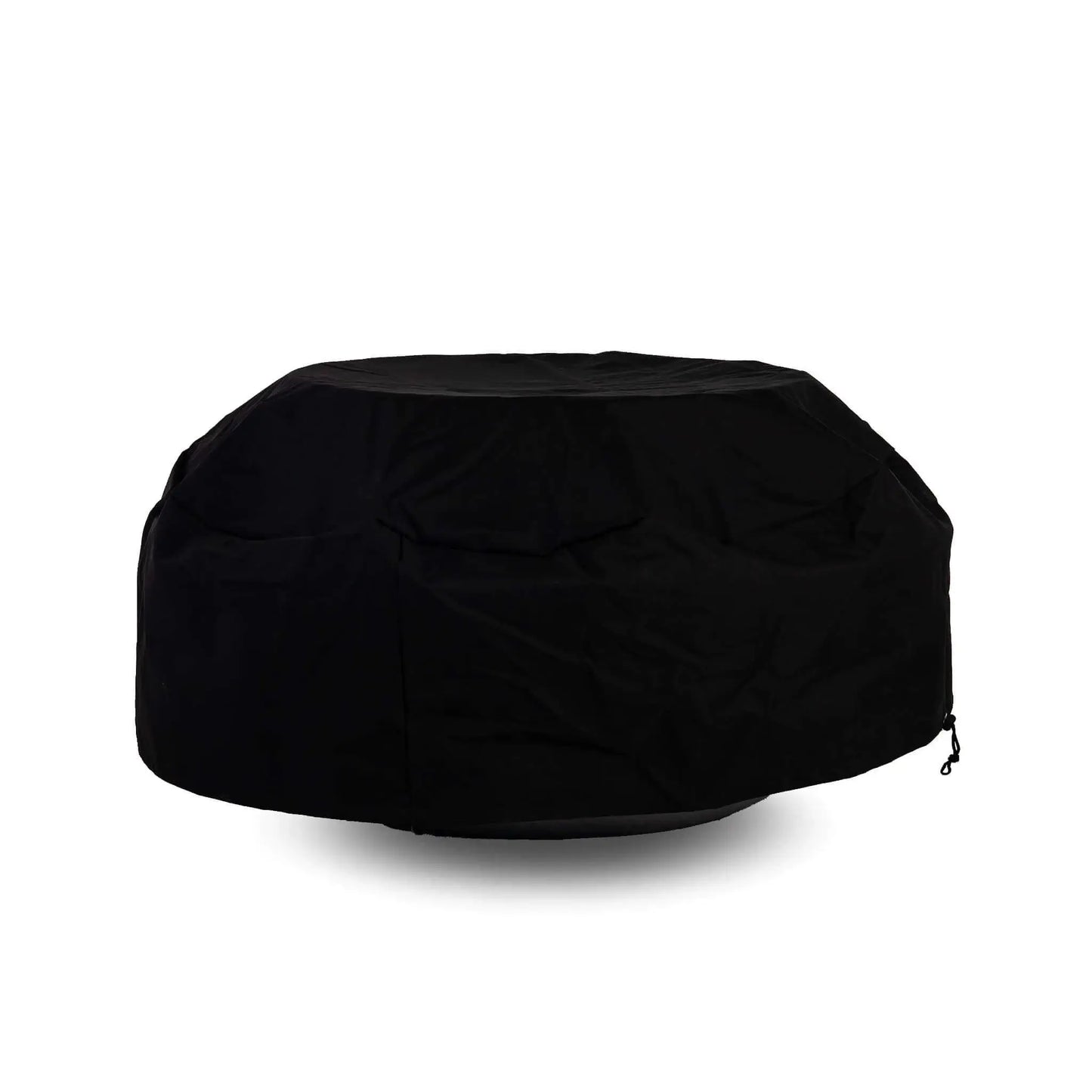 Side view of the Flame Havens Refuge Series 43-inch Round Natural Gas Black GFRC Concrete Fire Pit fitted with a black canvas fabric cover while a tempered glass wind guard remains installed underneath. The protective cover accommodates the wind guard, offering convenient weather protection without requiring accessory removal.