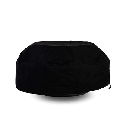 Side view of the Flame Havens Refuge Series 43-inch Round Natural Gas Black GFRC Concrete Fire Pit fitted with a black canvas fabric cover while a tempered glass wind guard remains installed underneath. The protective cover accommodates the wind guard, offering convenient weather protection without requiring accessory removal.