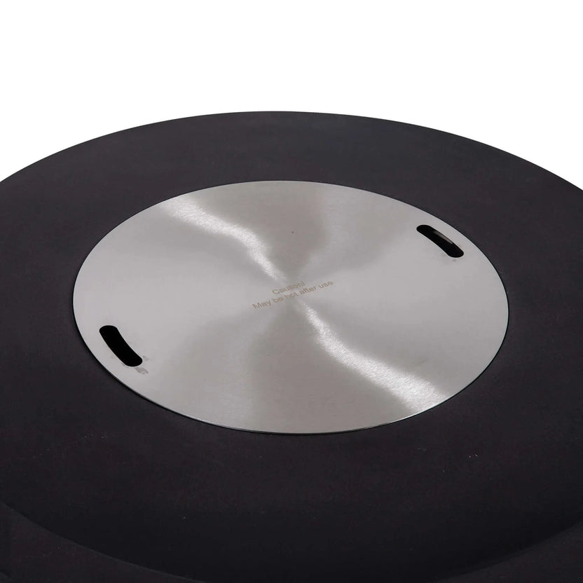 Top view of the Flame Havens Refuge Series 43-inch Round Natural Gas Black GFRC Concrete Fire Pit with the brushed stainless steel burner cover installed. The cover transforms the fire feature into a functional tabletop while preserving the clean circular design and protecting the burner system between uses.