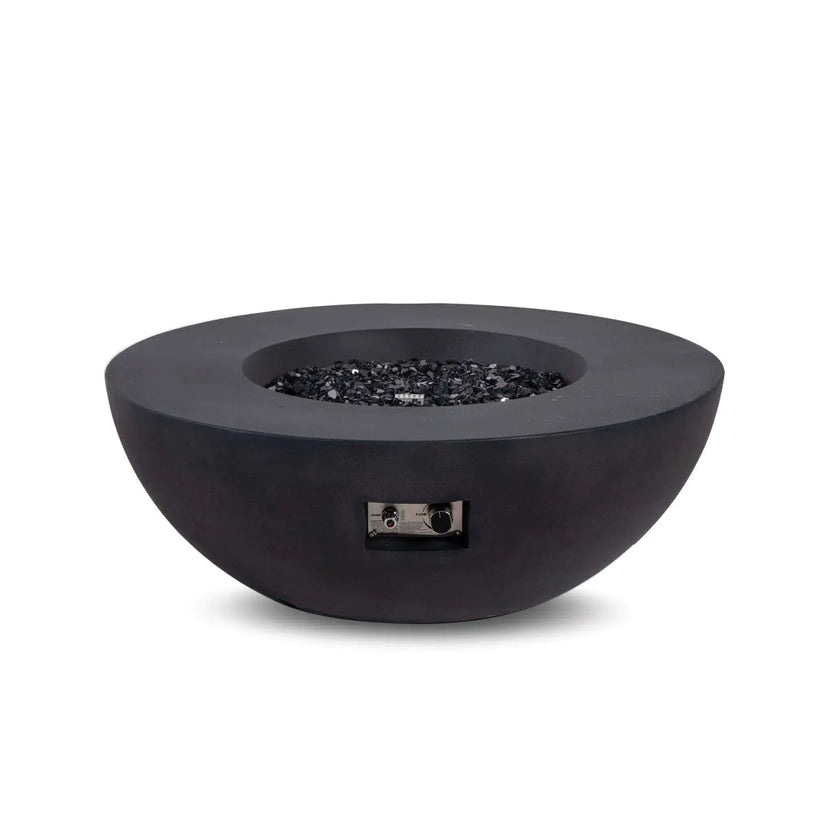 Front view of the Flame Havens Refuge Series 43-inch Round Natural Gas Black GFRC Concrete Fire Pit filled with reflective tempered black fire glass while the burner is off. The recessed control panel remains visible for easy access, showcasing the fire pit's modern appearance and premium materials before ignition.