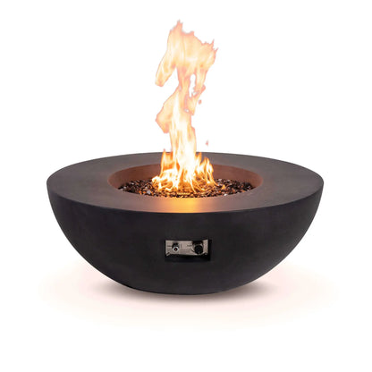 Front view of the Flame Havens Refuge Series 43-inch Round Natural Gas Black GFRC Concrete Fire Pit burning over reflective tempered black fire glass. The recessed control panel is visible beneath the bowl, combining convenient operation with a clean, modern design suited for premium outdoor gathering spaces.