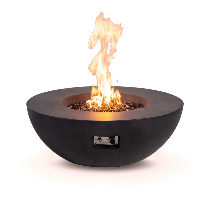 Front view of the Flame Havens Refuge Series 43-inch Round Natural Gas Black GFRC Concrete Fire Pit burning over reflective tempered black fire glass. The recessed control panel is visible beneath the bowl, combining convenient operation with a clean, modern design suited for premium outdoor gathering spaces.