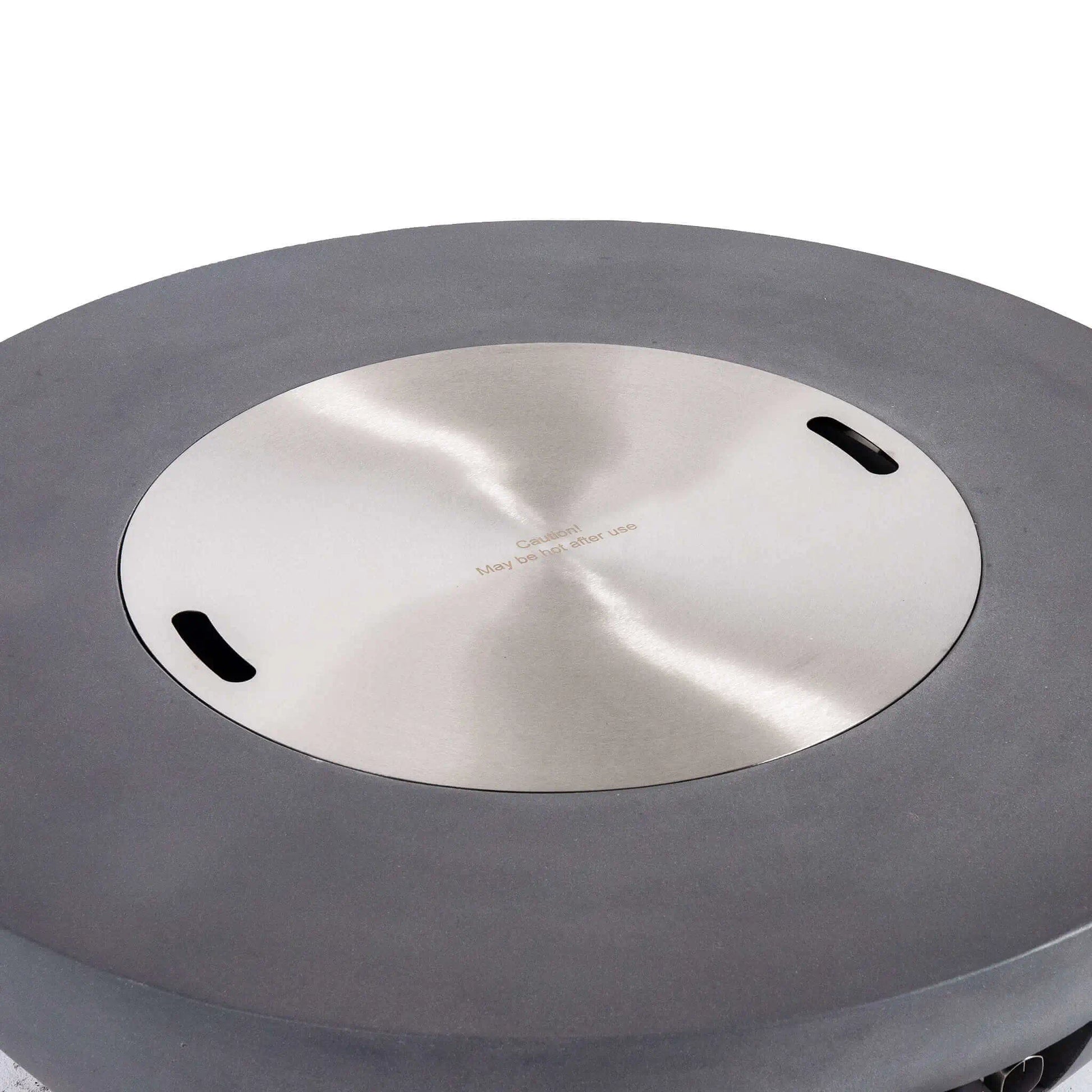 Top view of the Flame Havens Refuge Series 43-inch Round Natural Gas Gray GFRC Concrete Fire Pit with the precision-fit stainless steel burner cover installed. The brushed stainless cover sits flush within the recessed burner opening, transforming the fire pit into a functional tabletop while protecting the burner when not in use.
