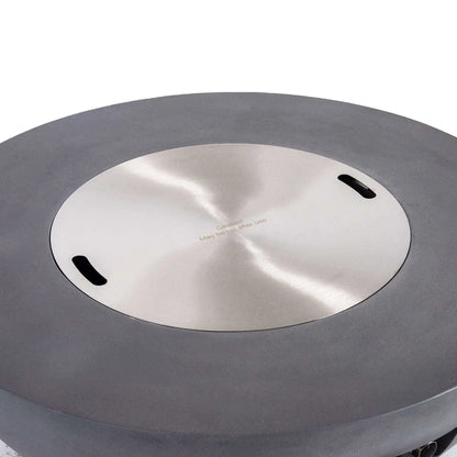 Top view of the Flame Havens Refuge Series 43-inch Round Natural Gas Gray GFRC Concrete Fire Pit with the precision-fit stainless steel burner cover installed. The brushed stainless cover sits flush within the recessed burner opening, transforming the fire pit into a functional tabletop while protecting the burner when not in use.