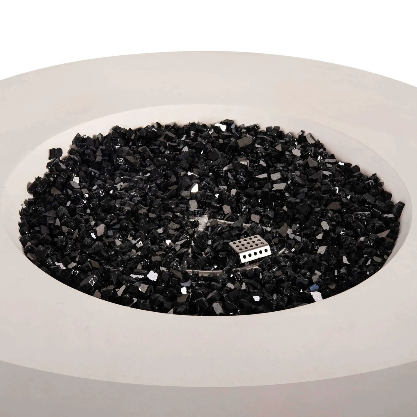Top view of the Flame Havens Refuge Series 43-inch Round Natural Gas White GFRC Concrete Fire Pit filled with reflective black fire glass. The premium fire media surrounds the stainless steel burner and ignition assembly, creating a clean, contemporary appearance before the natural gas fire is ignited.