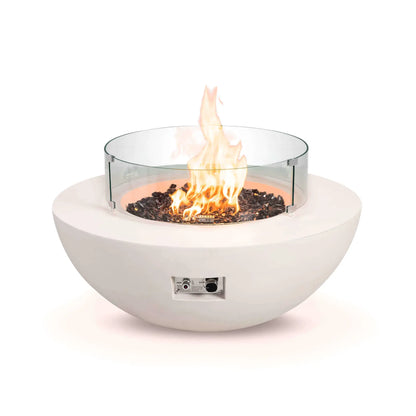 Front studio image of the Flame Havens Refuge Series 43-inch Round Natural Gas White GFRC Concrete Fire Pit equipped with a tempered glass wind guard. Reflective tempered black fire glass surrounds the natural gas flames while the clear circular wind guard helps protect and stabilize the flame without obstructing the view.