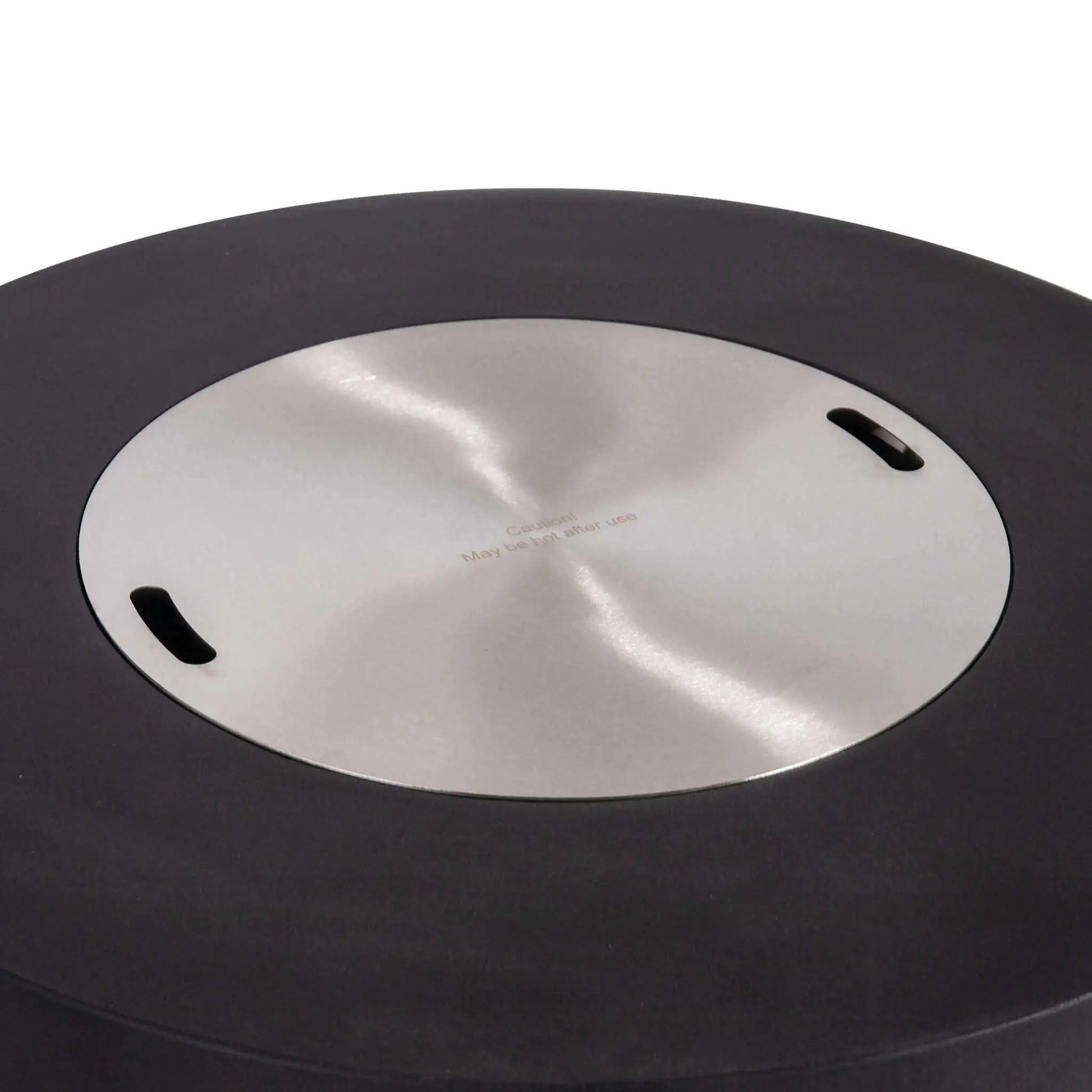 The Flame Havens Refuge Series 43-inch Round Propane Gas GFRC Concrete Fire Pit in Black featuring the optional stainless steel burner cover installed. The brushed stainless cover fits flush within the recessed burner opening, transforming the fire pit into a functional tabletop while protecting the burner. The image highlights the premium black GFRC concrete finish and clean, contemporary outdoor design.