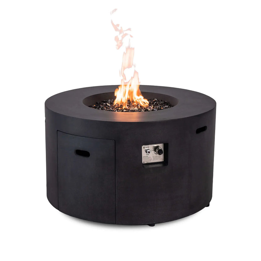The Flame Havens Refuge Series 43-inch Round Propane Gas GFRC Concrete Fire Pit in Black operating with a vibrant propane flame rising through premium black reflective fire glass. The recessed CSA-certified ignition control panel and hidden propane access door are visible, highlighting the luxury GFRC concrete construction, clean round design, and easy-to-use electronic ignition system.