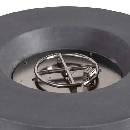 Close-up of the stainless steel circular burner and integrated CSA-certified ignition system inside the Flame Havens Refuge Series 43-inch Round Propane Gas GFRC Concrete Fire Pit in Gray. The image showcases the precision burner ring, ignition cage, and premium stainless steel components before black reflective fire glass is installed.