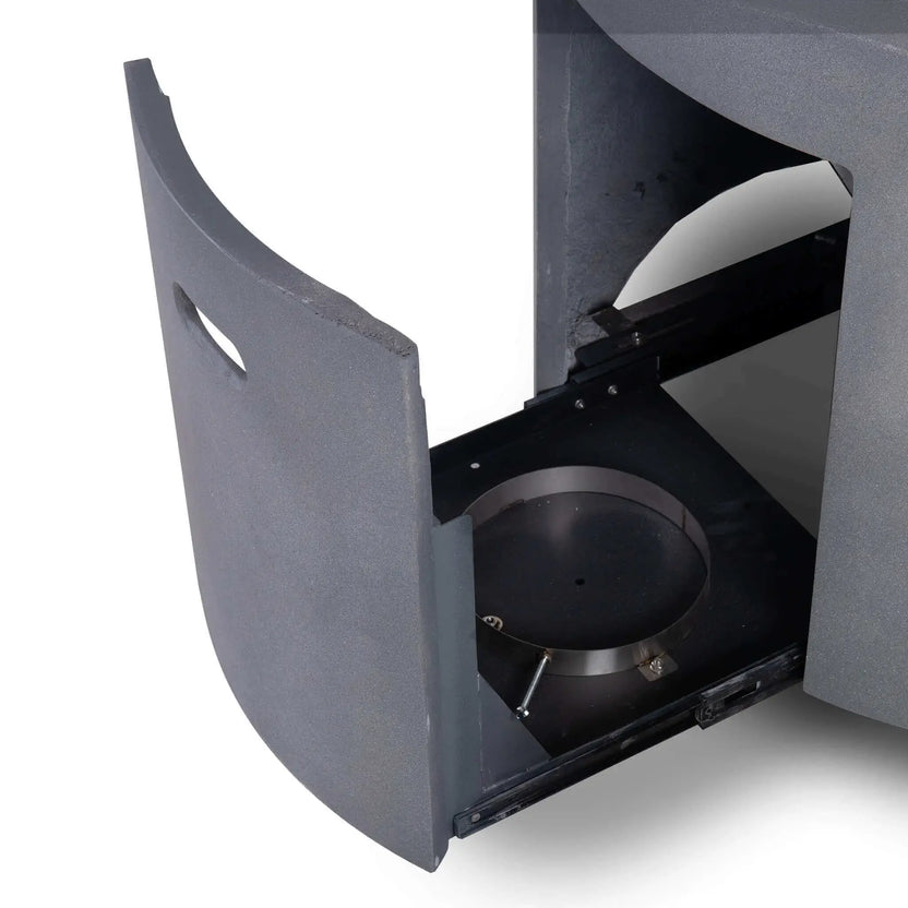 The Flame Havens Refuge Series 43-inch Round Propane Gas GFRC Concrete Fire Pit in Gray with the hidden propane drawer fully extended. The slide-out compartment provides convenient access for installing or servicing a standard propane tank while maintaining the fire pit's clean, seamless exterior appearance.
