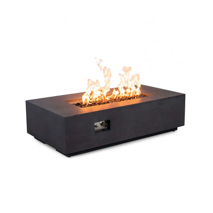 Angled view of the Flame Havens Refuge Series 56 x 30 x 15 inch rectangle black natural gas GFRC fire pit with flames rising from tempered black fire glass, showing the front control panel and modern low-profile concrete design on a white background.