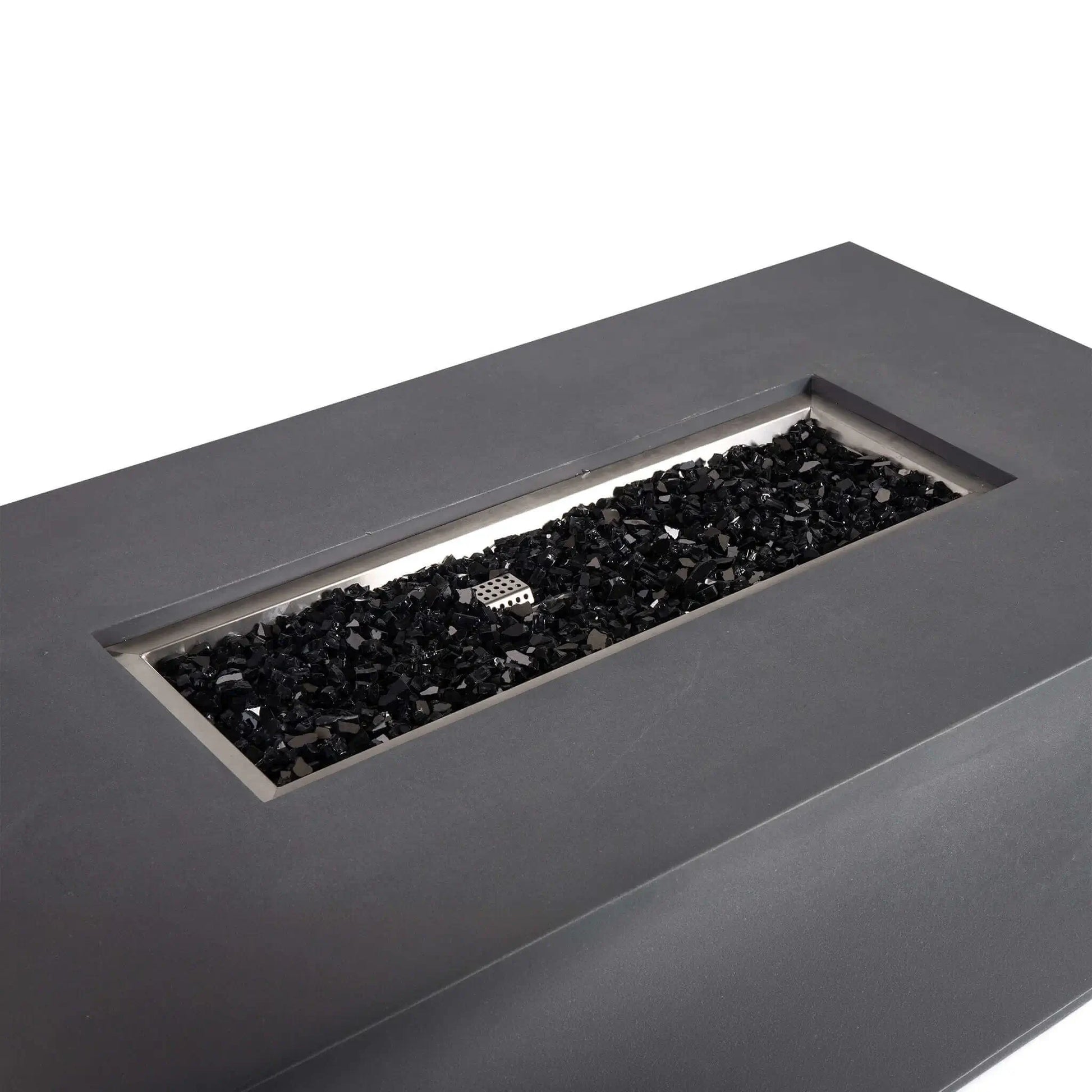 Angled top view of the Flame Havens Refuge Series 56 x 30 x 15 inch rectangle natural gas GFRC concrete fire pit in gray, showcasing the stainless steel burner pan filled with reflective tempered black fire glass. The image highlights the clean rectangular burner opening and modern architectural design.