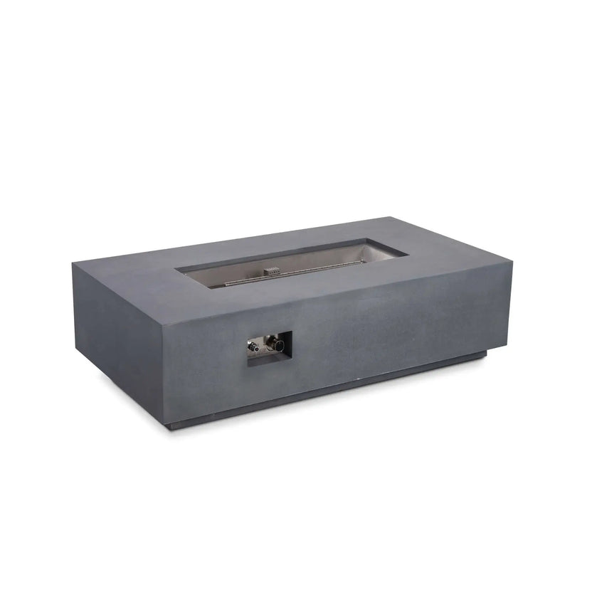Angled product view of the Flame Havens Refuge Series 56 x 30 x 15 inch rectangle natural gas gray GFRC concrete fire pit with the reflective tempered black fire glass removed, exposing the stainless steel burner pan, linear burner, and CSA-certified ignition system for installation and maintenance visibility.