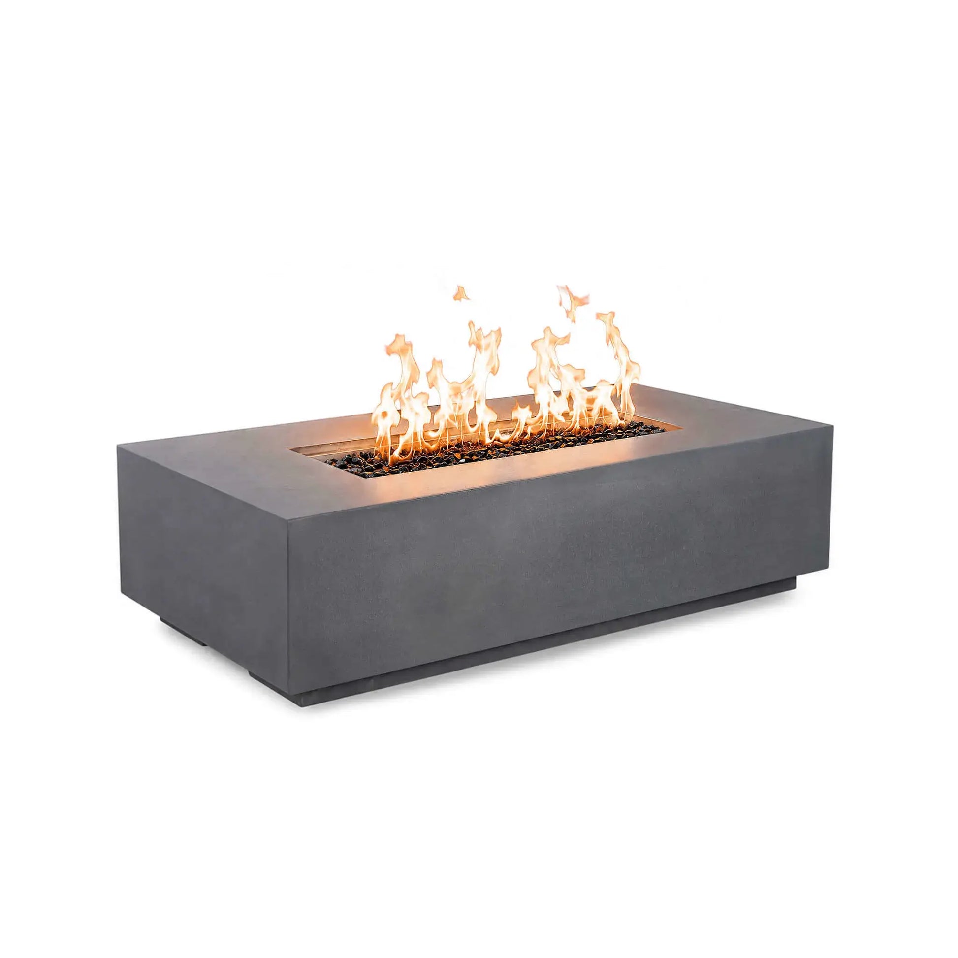 Angled front view of the Flame Havens Refuge Series 56 x 30 x 15 inch rectangle natural gas gray GFRC fire pit burning with bright flames over reflective tempered black fire glass. The streamlined design features concealed controls, creating a clean, contemporary appearance.