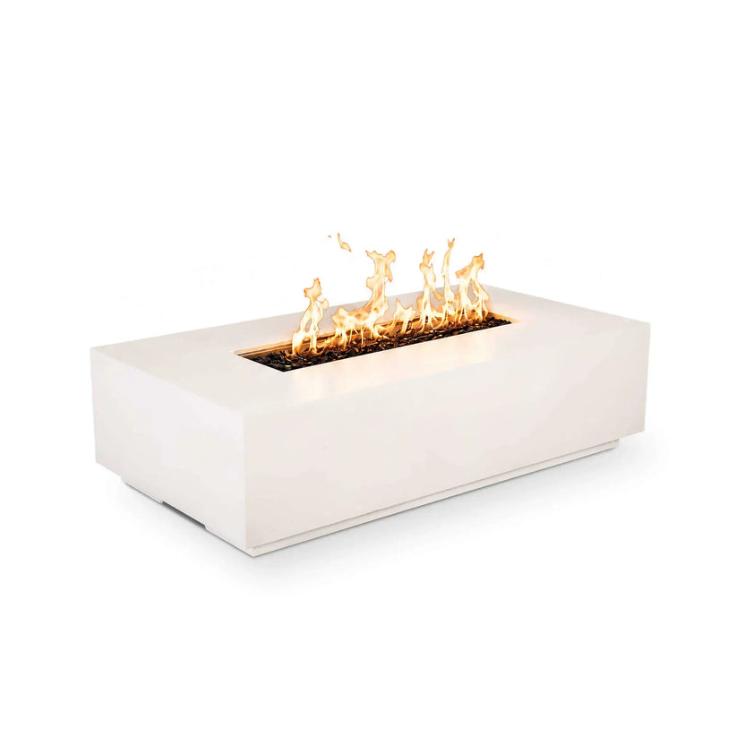 Angled product image of the Flame Havens Refuge Series 56 x 30 x 15 inch rectangle natural gas white GFRC concrete fire pit burning with vibrant flames over reflective tempered black fire glass. The clean front profile without visible controls highlights the minimalist design and modern linear burner presentation.