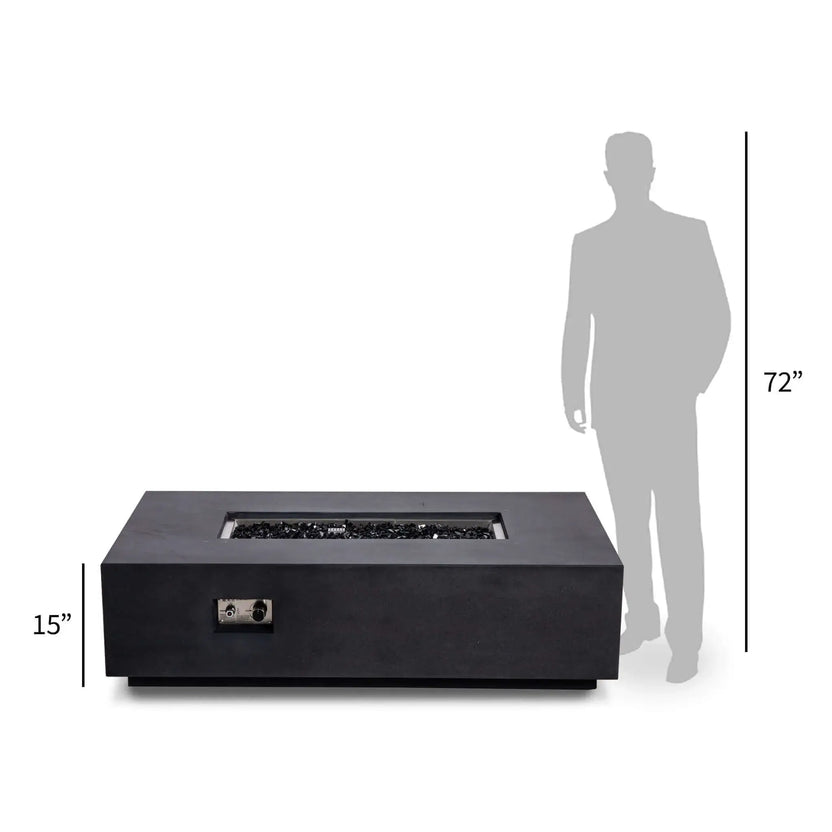 Front perspective of the Flame Havens Refuge Series 56 x 30 x 15 inch rectangle natural gas black GFRC concrete fire pit with reflective black fire glass, shown beside a 72-inch human silhouette for size comparison, emphasizing its low-profile modern design.