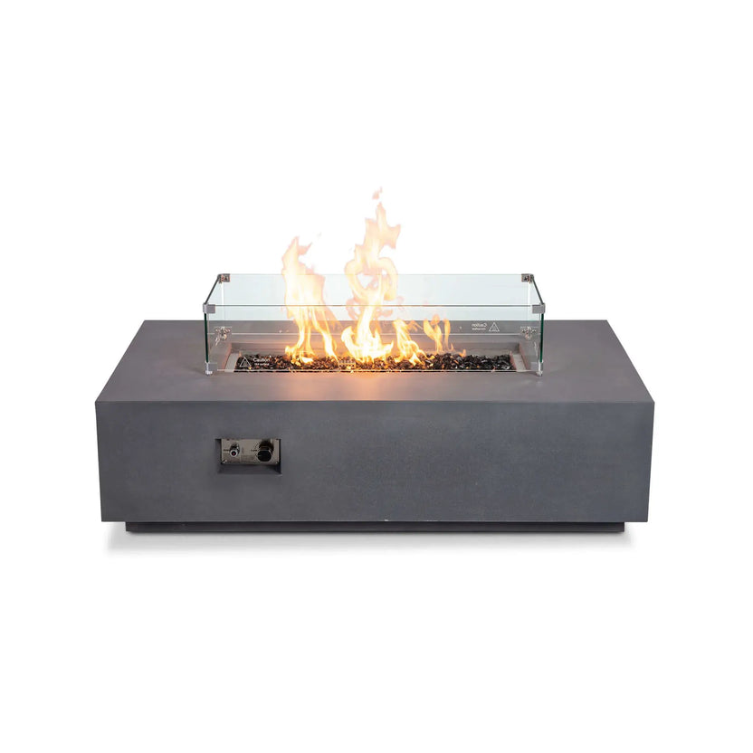 Straight-on product image of the Flame Havens Refuge Series 56 x 30 x 15 inch rectangle natural gas gray GFRC fire pit featuring a tempered glass wind guard and reflective tempered black fire glass. Bright flames rise evenly through the linear burner while the transparent wind guard protects the flame without obstructing the contemporary design.