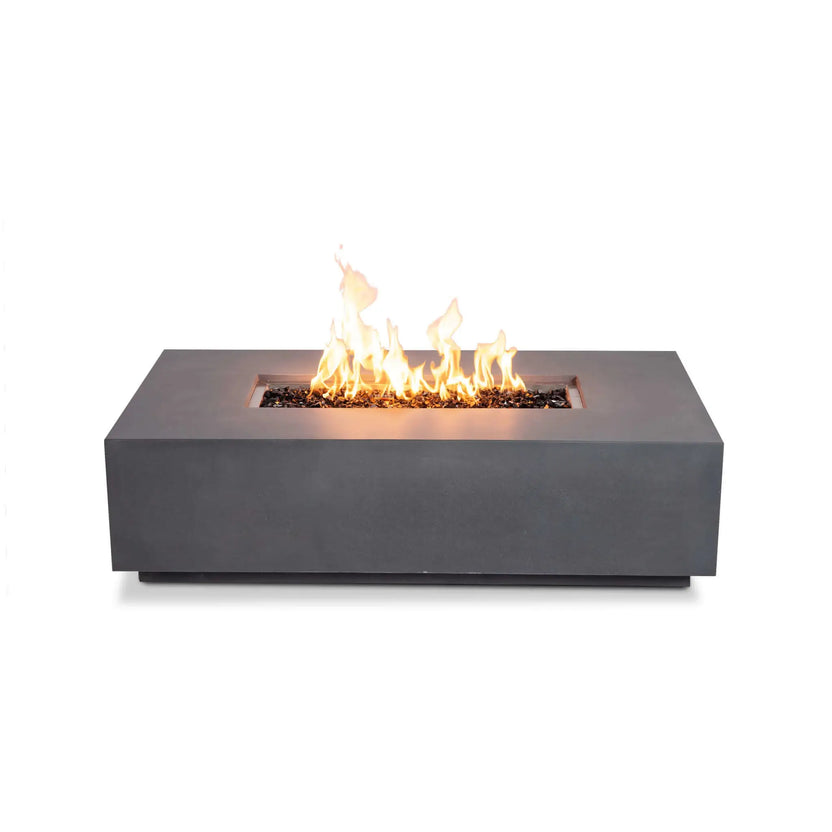 Straight-on front view of the Flame Havens Refuge Series 56 x 30 x 15 inch rectangle natural gas gray GFRC concrete fire pit burning with tall flames over reflective tempered black fire glass. This clean product image showcases the minimalist front profile without visible controls, highlighting the linear stainless steel burner and modern architectural design.