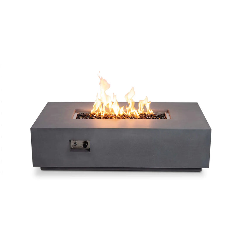 Straight front view of the Flame Havens Refuge Series 56 x 30 x 15 inch rectangle natural gas gray GFRC fire pit burning over reflective tempered black fire glass. The recessed stainless steel control panel is visible on the front, highlighting the integrated ignition system while emphasizing the fire pit's clean, low-profile contemporary design.