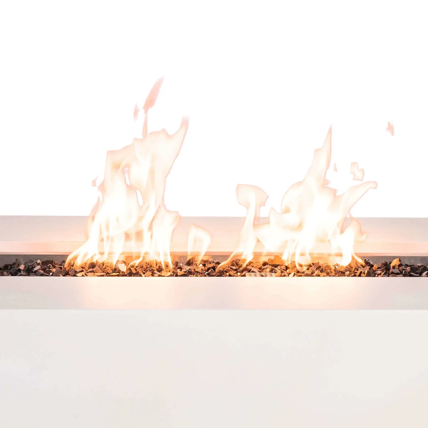 Close-up of the Flame Havens Refuge Series 56 x 30 x 15 inch rectangle natural gas white GFRC concrete fire pit showcasing tall, vibrant flames dancing across reflective tempered black fire glass. The linear burner creates an even flame pattern while highlighting the clean contemporary design and premium outdoor fire feature construction.
