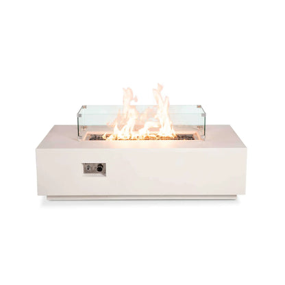 Front view of the Flame Havens Refuge Series 56 x 30 x 15 inch rectangle natural gas white GFRC concrete fire pit featuring the tempered glass wind guard and reflective tempered black fire glass. Tall flames burn evenly inside the clear wind guard, highlighting the modern rectangular design while maintaining unobstructed views from every angle.