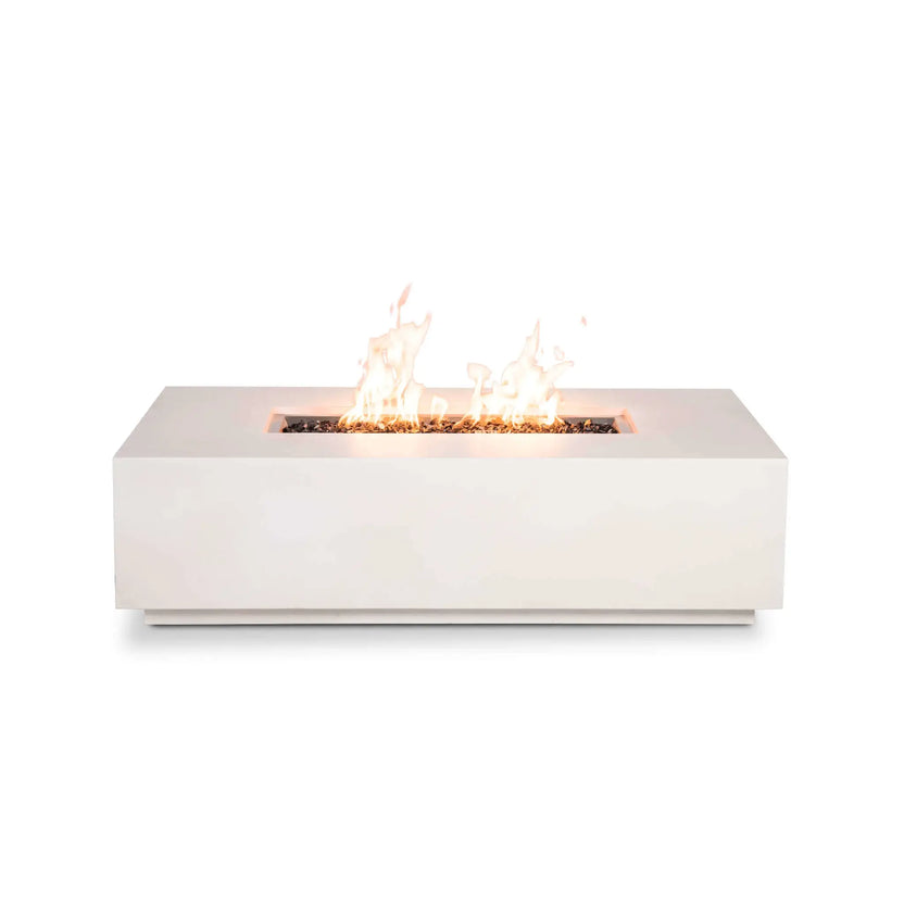 Straight-on product image of the Flame Havens Refuge Series 56 x 30 x 15 inch rectangle natural gas white GFRC concrete fire pit with vibrant flames rising above reflective tempered black fire glass. The clean front profile without visible controls emphasizes the minimalist contemporary design, low-profile construction, and premium linear stainless steel burner.