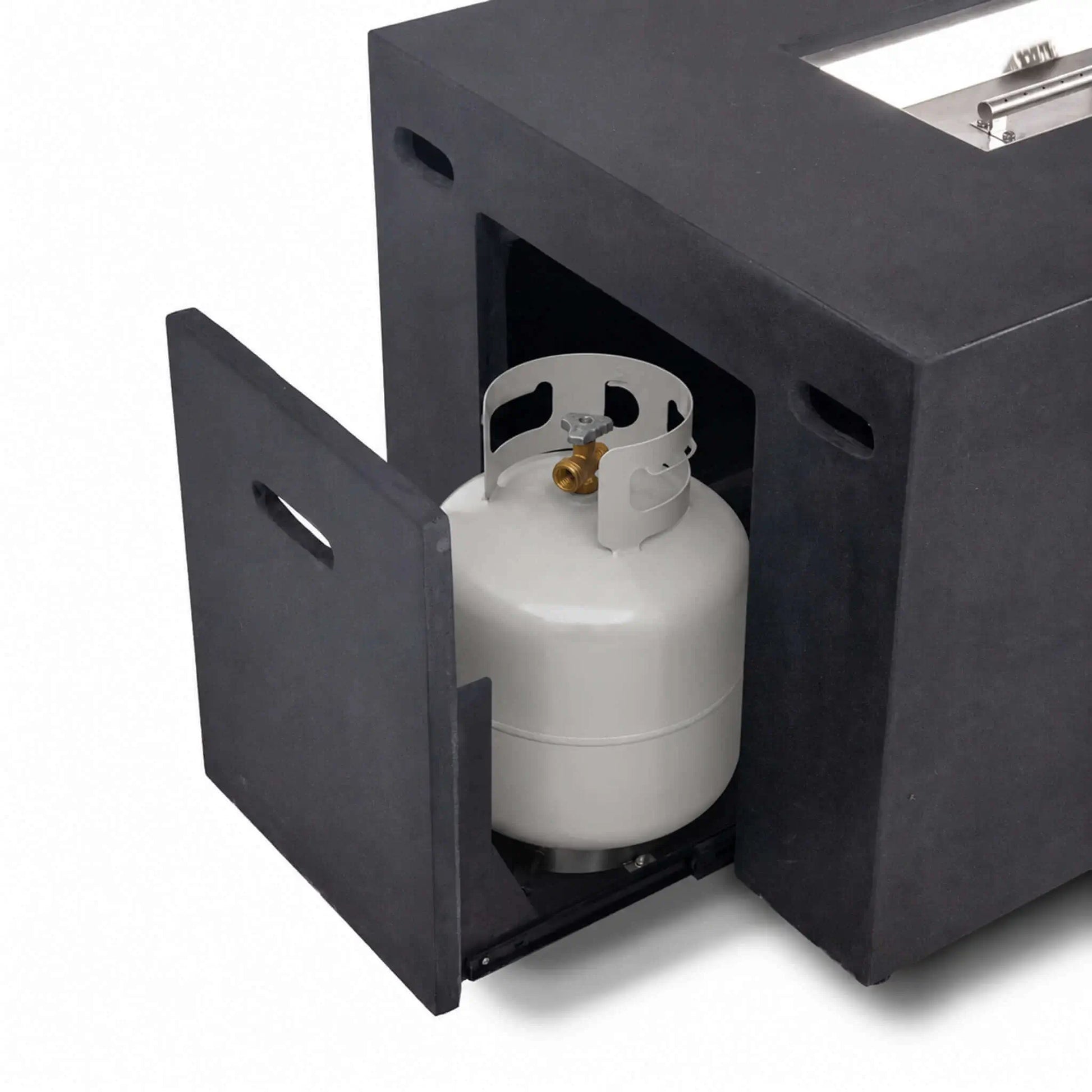 Open hidden propane tank drawer with a standard propane cylinder inside the black Flame Havens Refuge Series 56 x 30 x 24-inch rectangular GFRC concrete fire pit, demonstrating the concealed slide-out tank storage and easy-access door design.