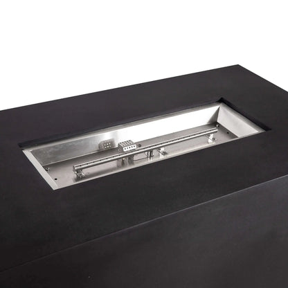 Close-up of the recessed stainless steel burner assembly in the black Flame Havens Refuge Series 56 x 30 x 24-inch rectangular GFRC concrete propane fire pit, showing the linear burner tube, burner ports, mounting hardware, and protected CSA ignition components.