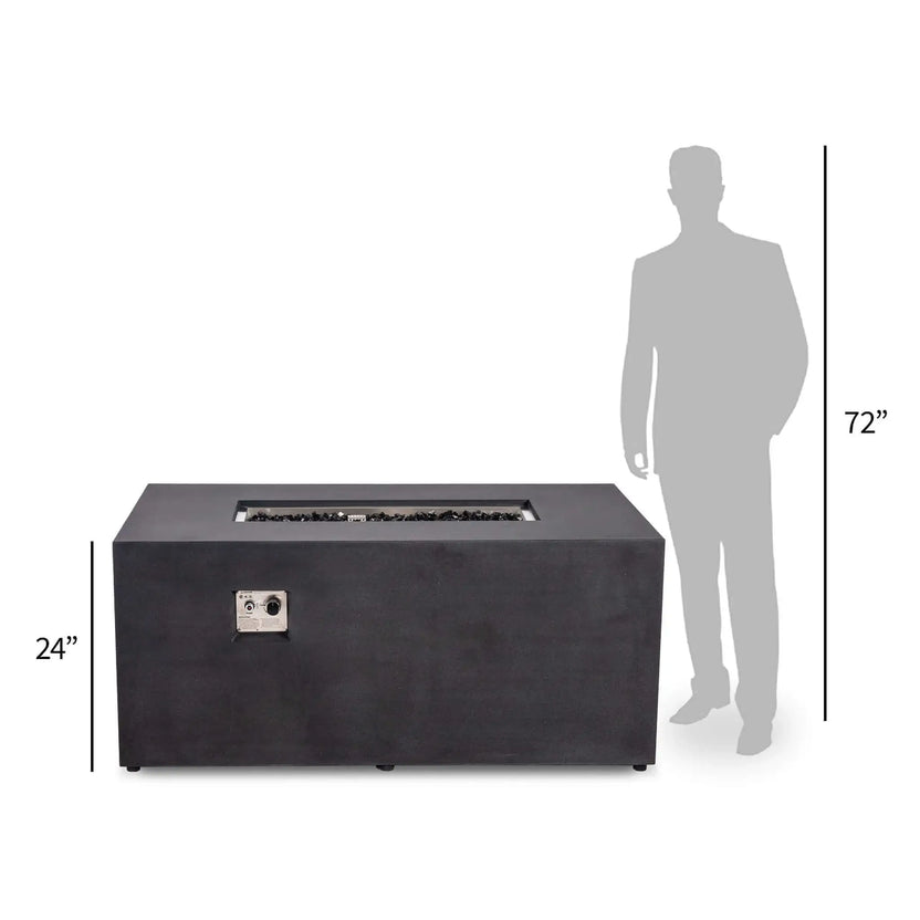 Size comparison showing the black Flame Havens Refuge Series 56 x 30 x 24-inch rectangular GFRC propane fire pit beside a 72-inch human silhouette. The front perspective highlights the fire pit’s 24-inch height, black fire glass, recessed CSA ignition controls, and substantial outdoor table proportions.