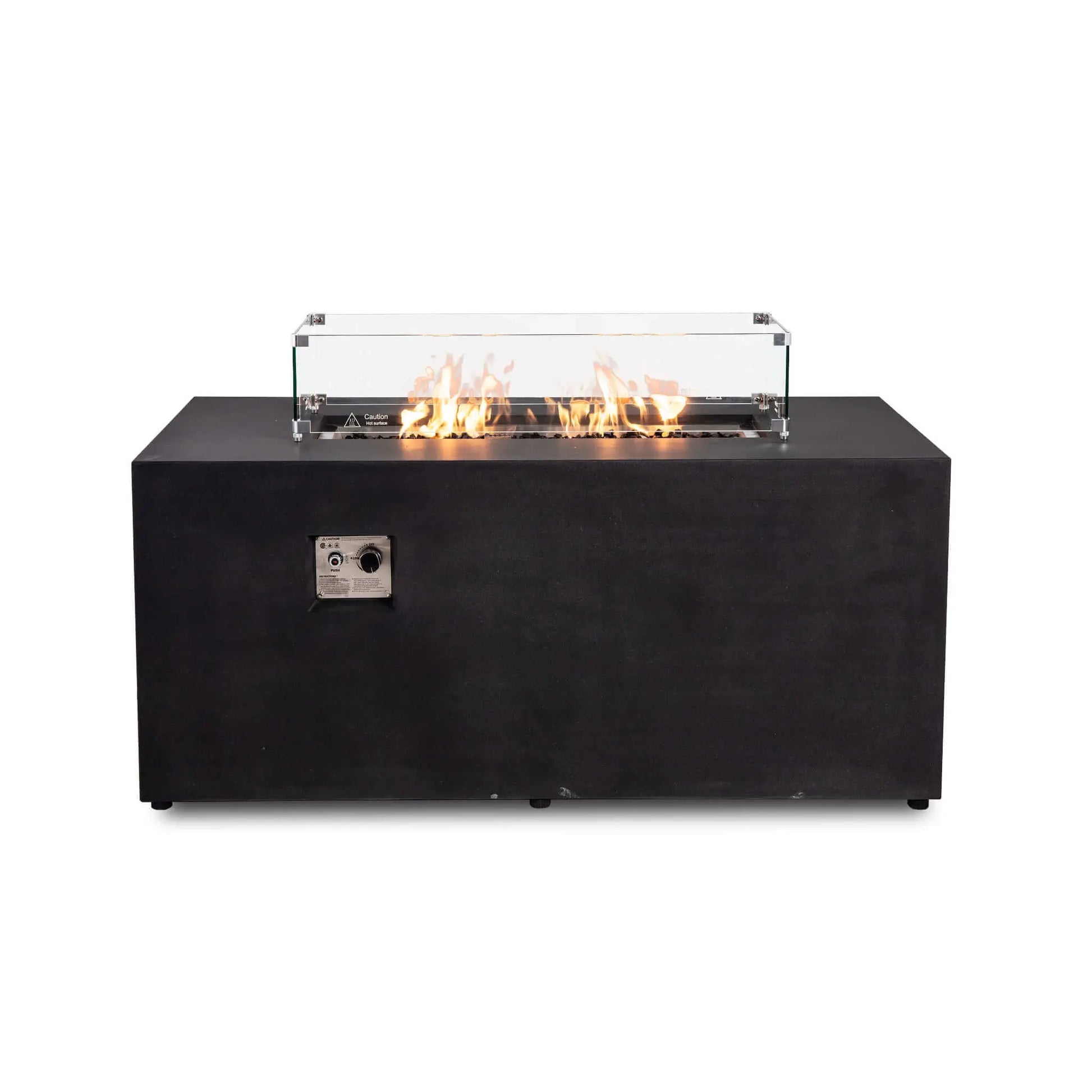 Straight view of the black Flame Havens Refuge Series 56 x 30 x 24-inch rectangular GFRC propane fire pit with an active flame over tempered black fire glass. A clear glass wind guard surrounds the burner and features metal corner brackets, raised feet, and a hot-surface warning.
